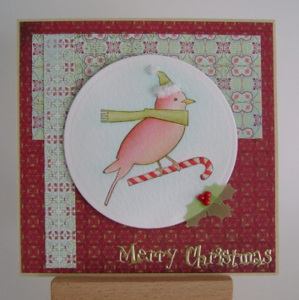 red bird on candy cane wearing a hat and scarf