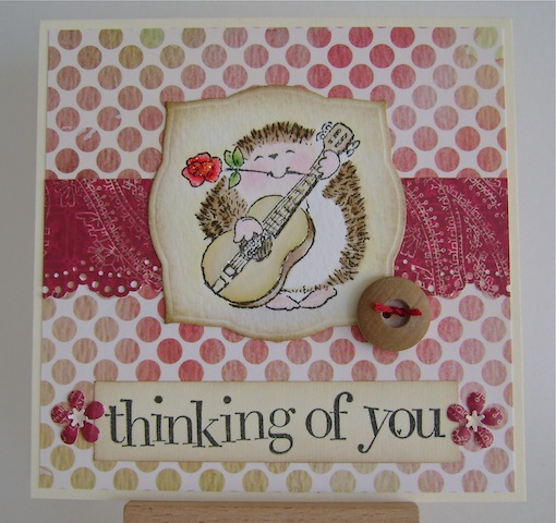 guitar playing hedgehog on red and beige dotted background