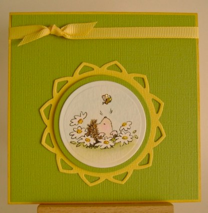 hedgehog poking its head out of the ground surrounded by flowers