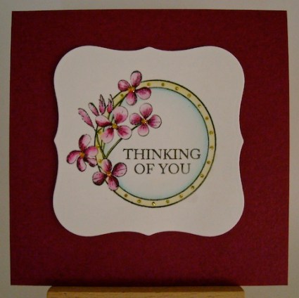 circle framed flowers on berry coloured square card base