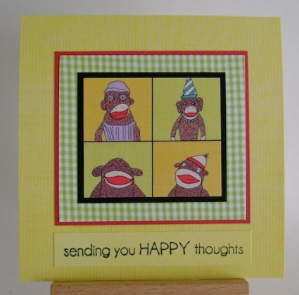 four sock monkeys in a square on square yellow card