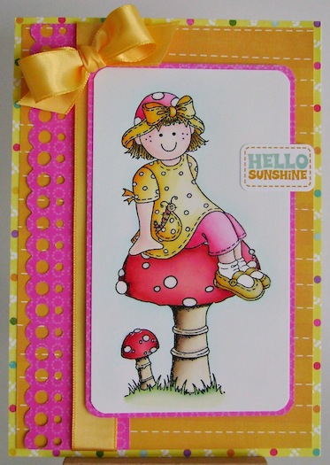 molly sitting on a toadstool card in pink, orange, yellow and red with hello sunshine sentiment