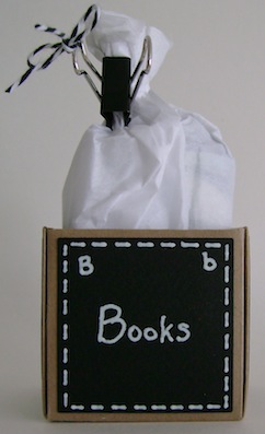 little box with the word books on black paper