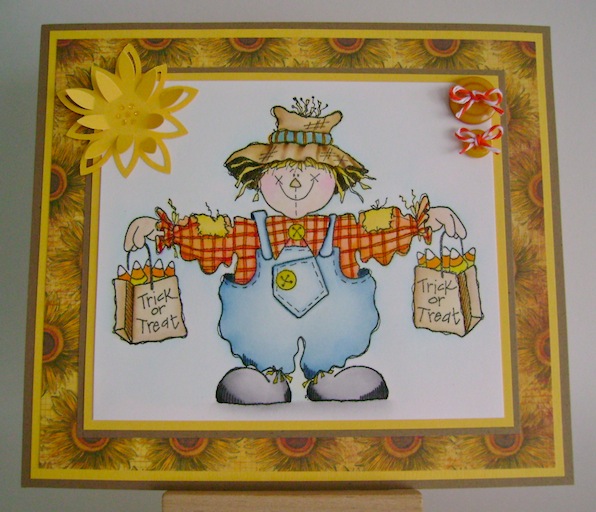 pbscarecrow scarecrow holding bags of candy corn with trick or treat sentiment on bags