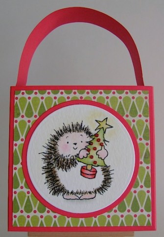hedgietote red tote bag with hedgie carrying a christmas tree image on the front