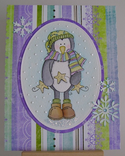 christmas card nontraditional colours featuring penguin holding garland of stars