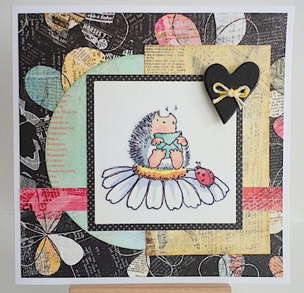 card featuring hedgehog sitting on daisy with ladybug and heart
