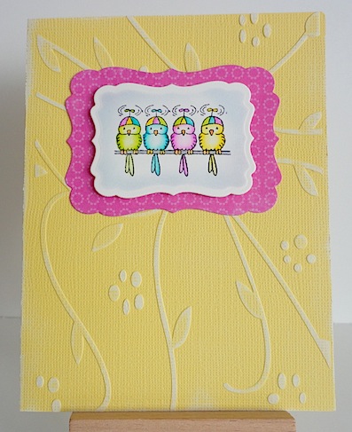 four birds on a wire in pink, blue, yellow, green on a yellow card base