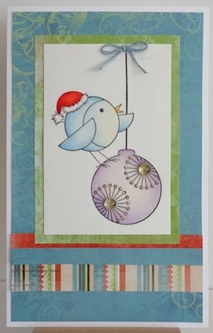 christmas card with blue bird on a purple ornament