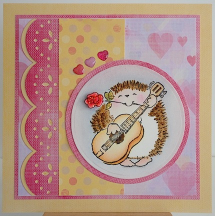 card with hedgie playing guitar in pinks and yellow