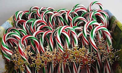 box of red and green candy canes with gold snowflakes
