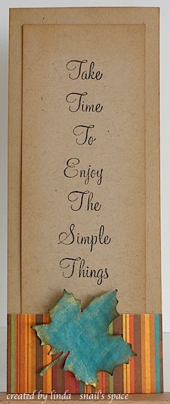 kraft paper bookmark with fall striped paper, a teal maple leaf die cut and edged with gold shimmer paint