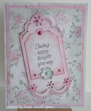 card with tag, pearls and a flower in pink and green