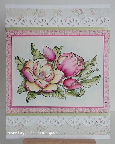 card with pink magnolias, green leaves and pink and green paper with two lacy punched borders