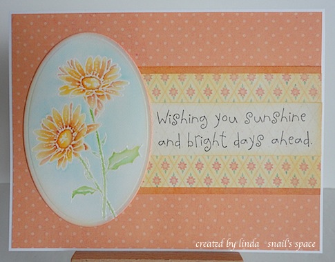 orange card with two yellow and orange daisies