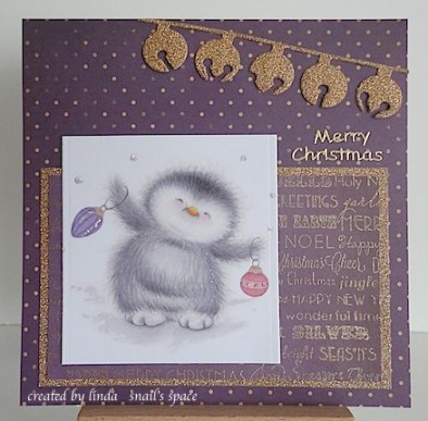 christmas card in purple and gold with a penguin and jingle bells