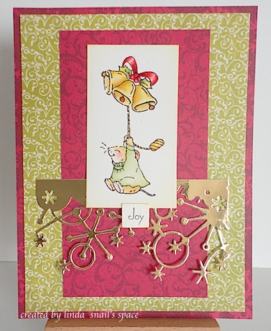 christmas card in red green and gold with mouse flying through the air with gold bells