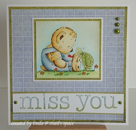card with teddy in blue coveralls sitting on the ground with a turtle and a miss you sentiment