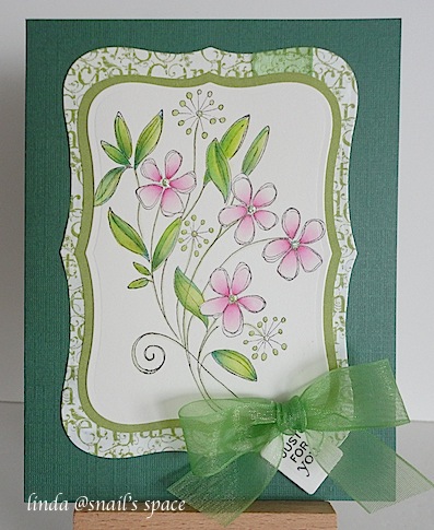 copyright linda @ snail's space and described here solely for people with disabilities; a card with pink wildflowers, green leaves, green text border on a green card base with a sheer green ribbon and a just for you sentiment stamped on a tiny tag