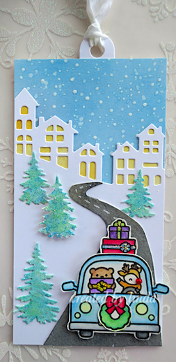 Rudolph driving a car in front of a holiday scene, a tag for Ellen Hutson's twelve tags 2021 challenge