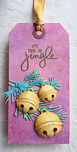 day 6 of Ellen Hutson's twelve tags 2021 challenge featuring gold jingle bells on a pink and purple background